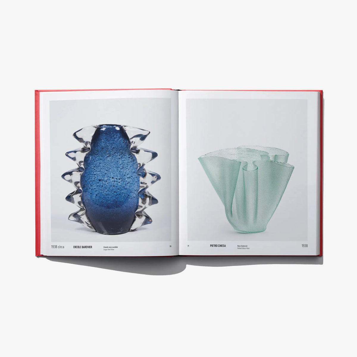 Open design book spread showing a blue glass vase and a mint green vase