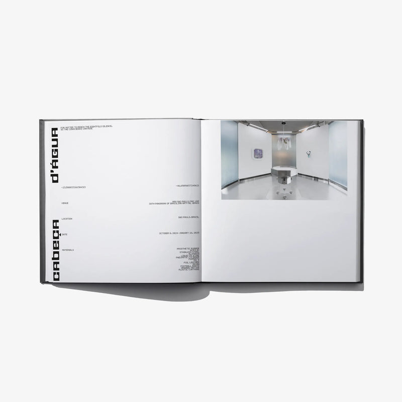 Open hardcover book with minimalist layout and a gallery interior photo