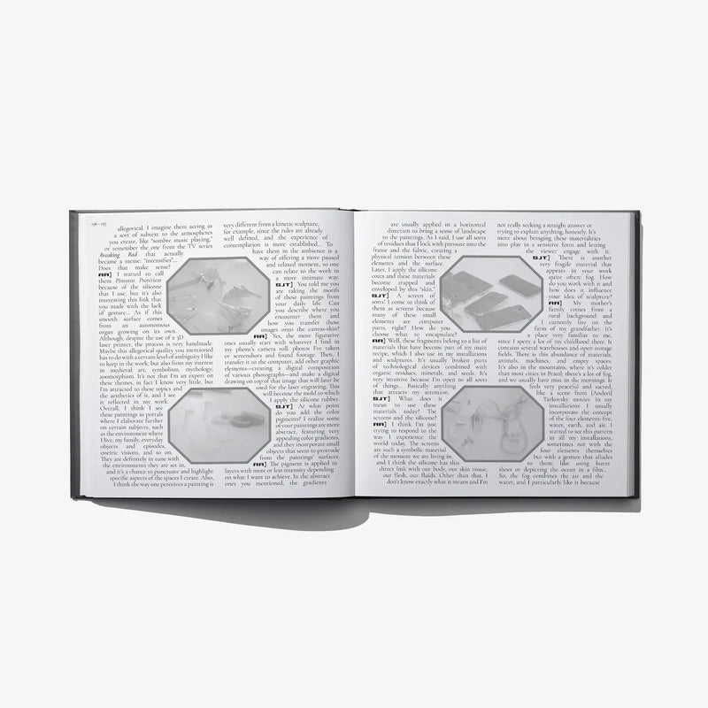 Open hardcover book with dense paragraphs and small gray illustration blocks