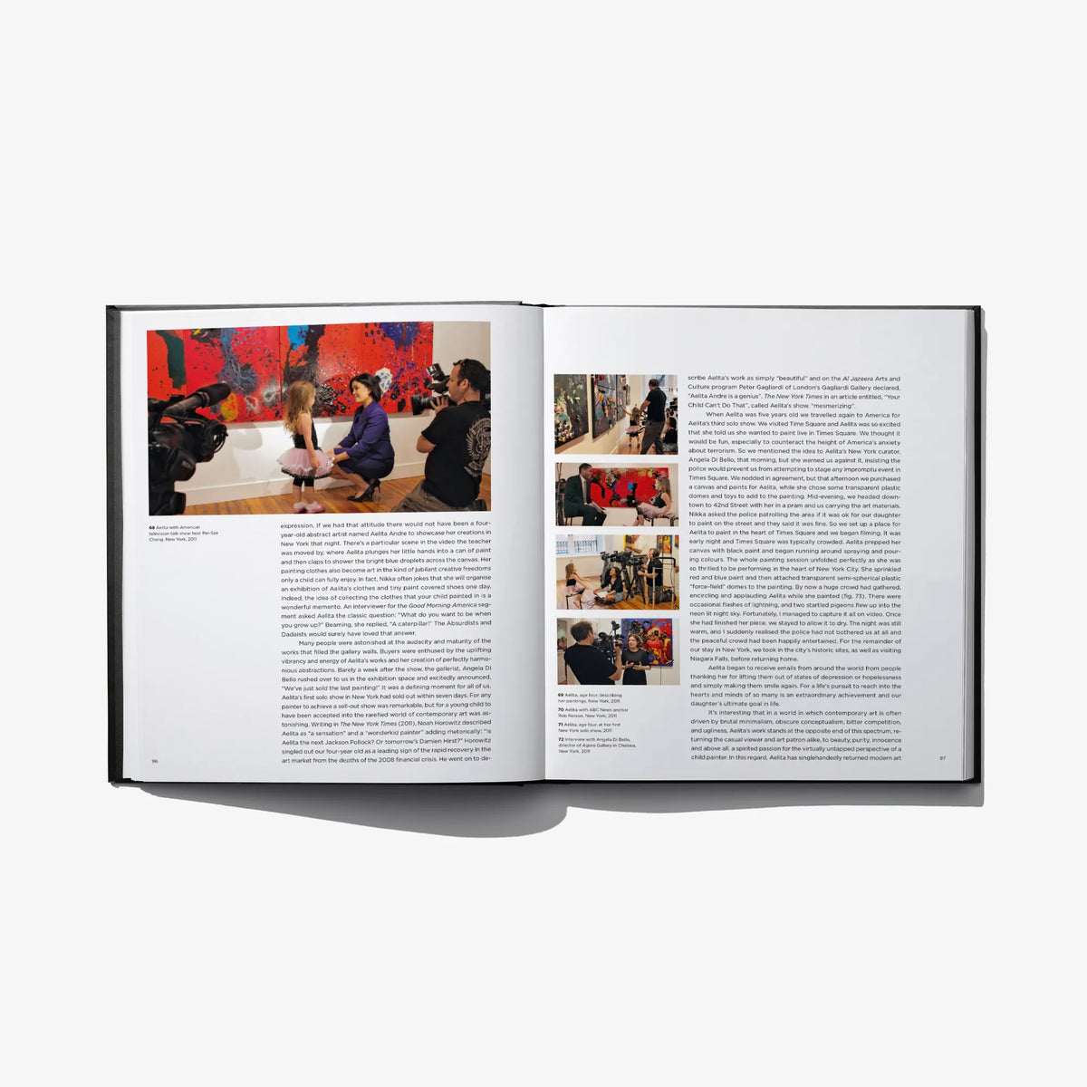 Open art book spread with group painting photos and dense printed text