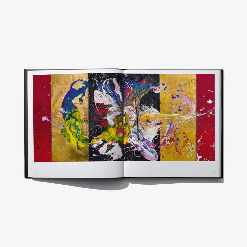 Open art book with wide abstract collage artwork across both pages