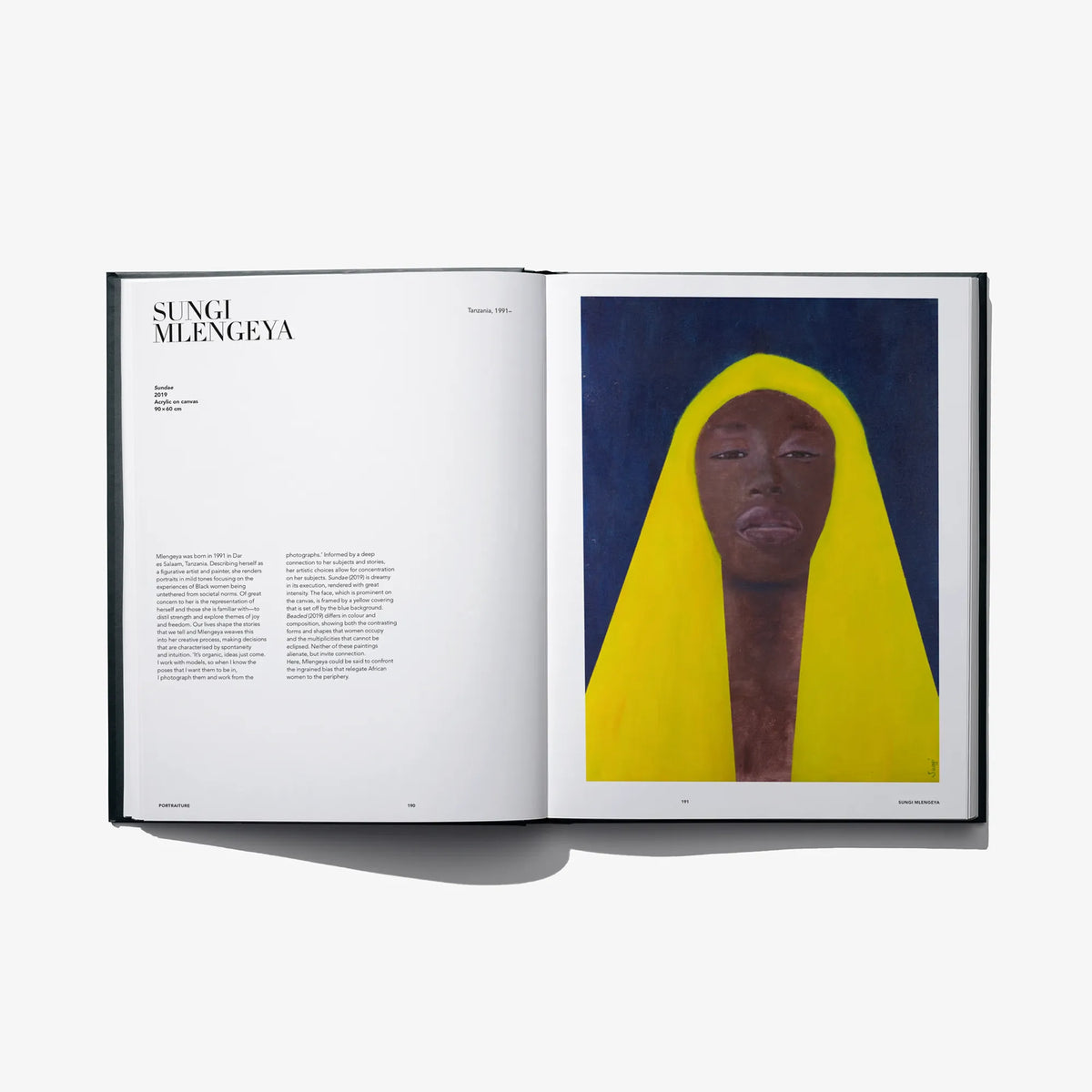 Open art book spread with a portrait of a person in a bright yellow hood
