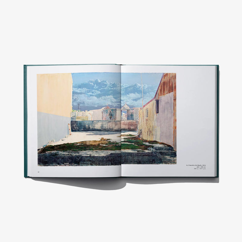 Open art book spread with illustrated buildings and courtyard scene across pages