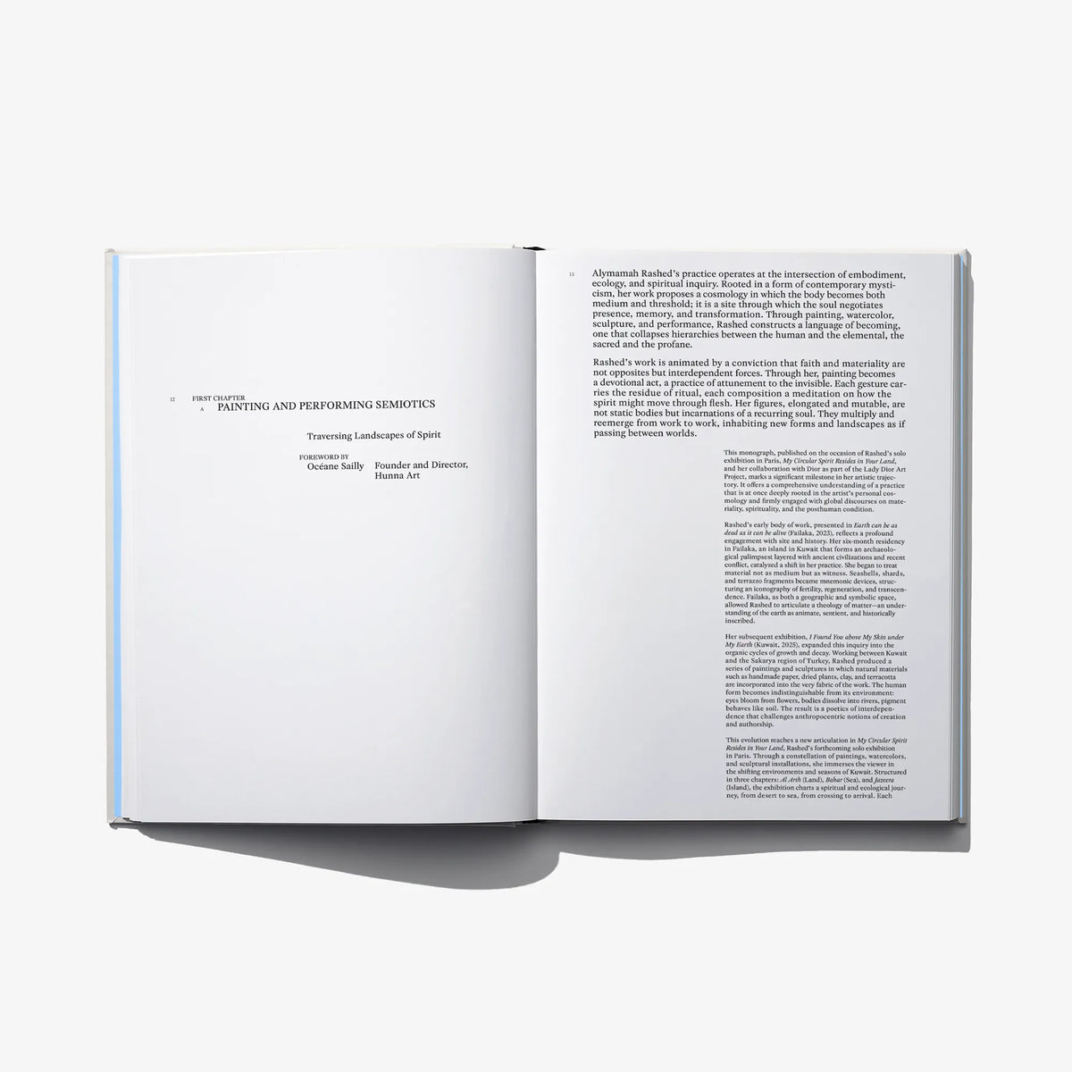 Open hardcover art book spread with paragraphs and blocks of text