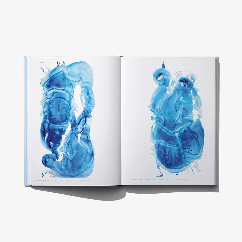 Open art book spread with blue watercolor-style character illustrations