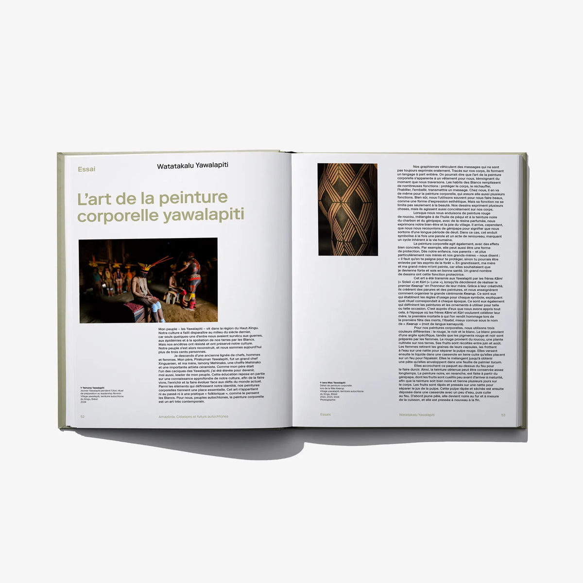 Open Amazonia book spread with body-painting artwork and a dense text section