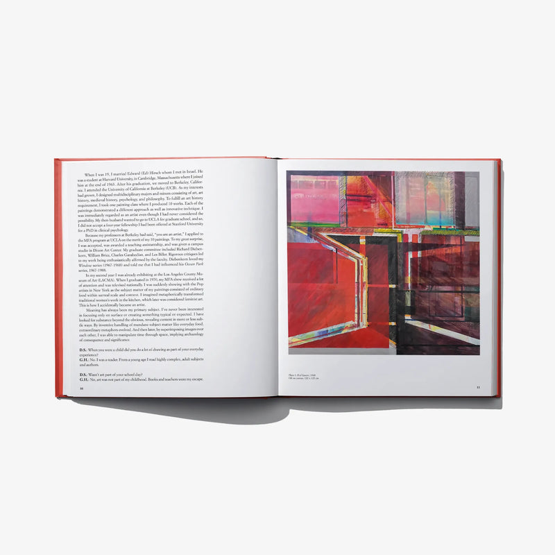 Hardcover book open spread with abstract artwork and printed text pages