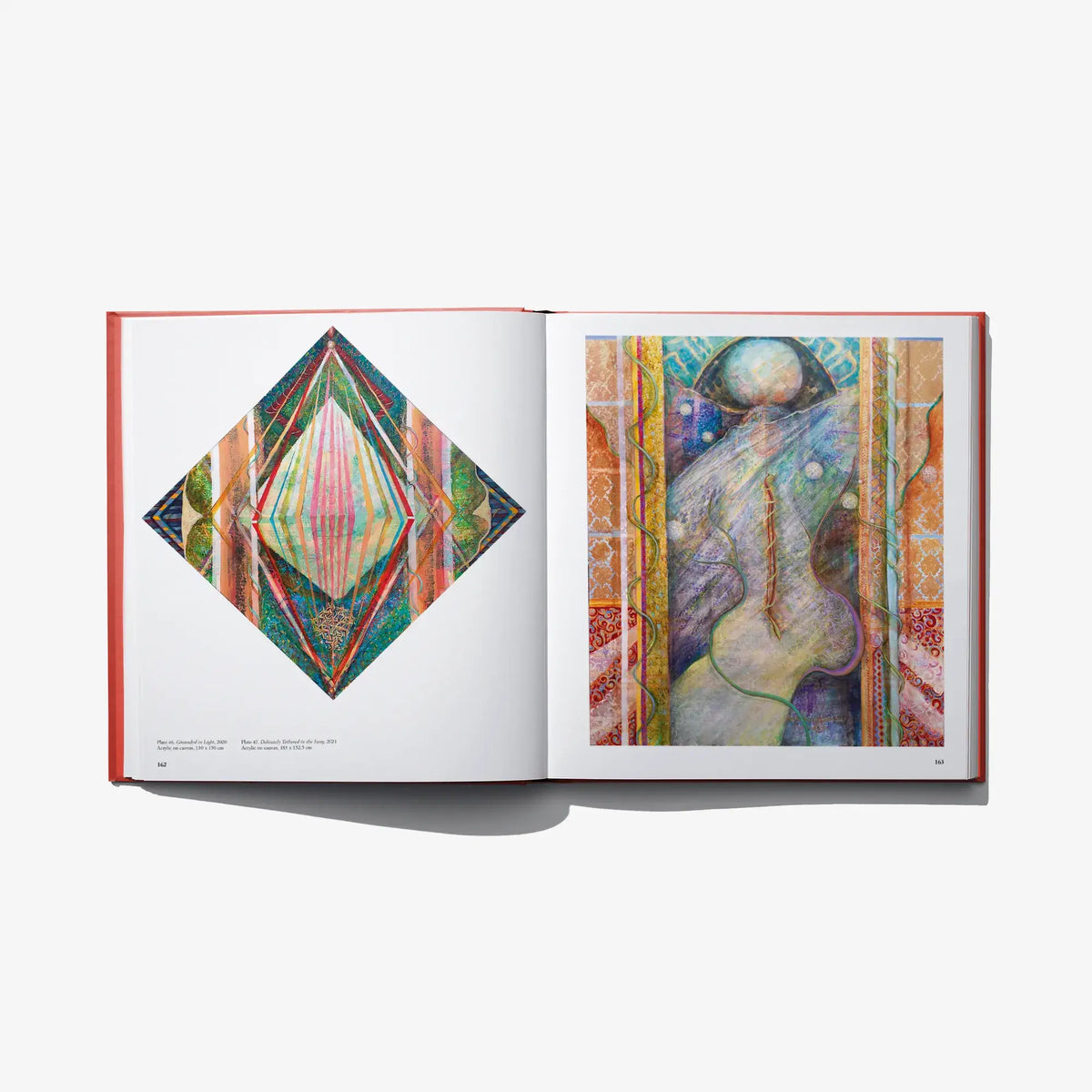 Hardcover book open spread with diamond artwork and ornate portrait painting