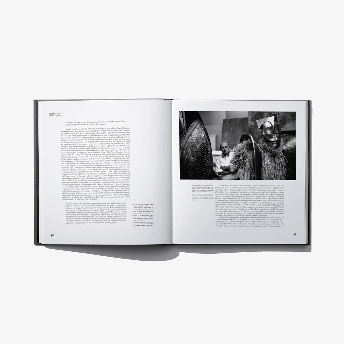 Open hardcover book showing two-page text and black-and-white portrait photograph