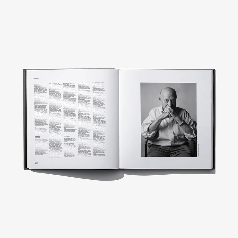 Open hardcover book with page text and black-and-white seated portrait photo