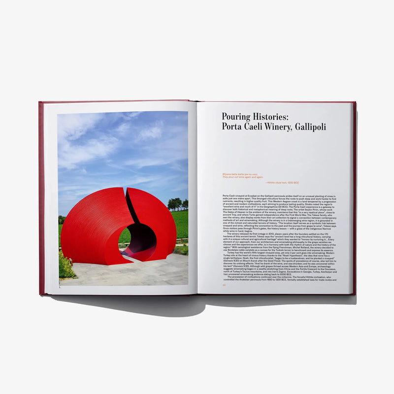 Open book spread with red circular outdoor sculpture photo on left and text on right page.
