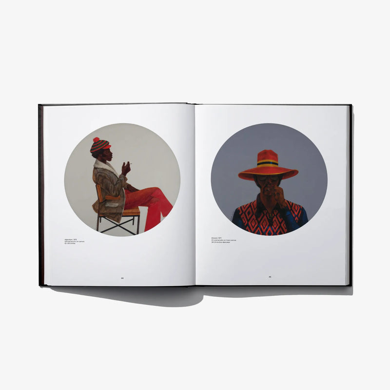 Open photo art book spread with two circular portraits of men in hats