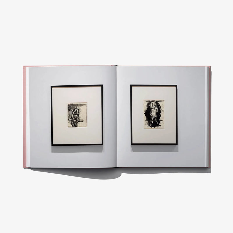 Open art book spread with two framed black-and-white prints