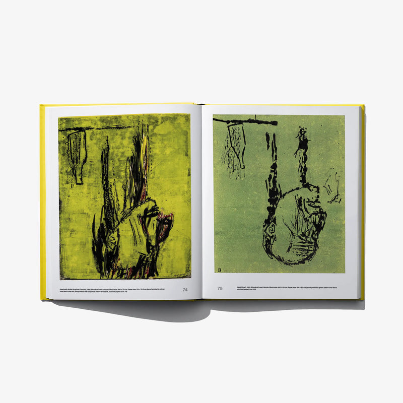 Opened art book with two green-toned abstract prints on white pages