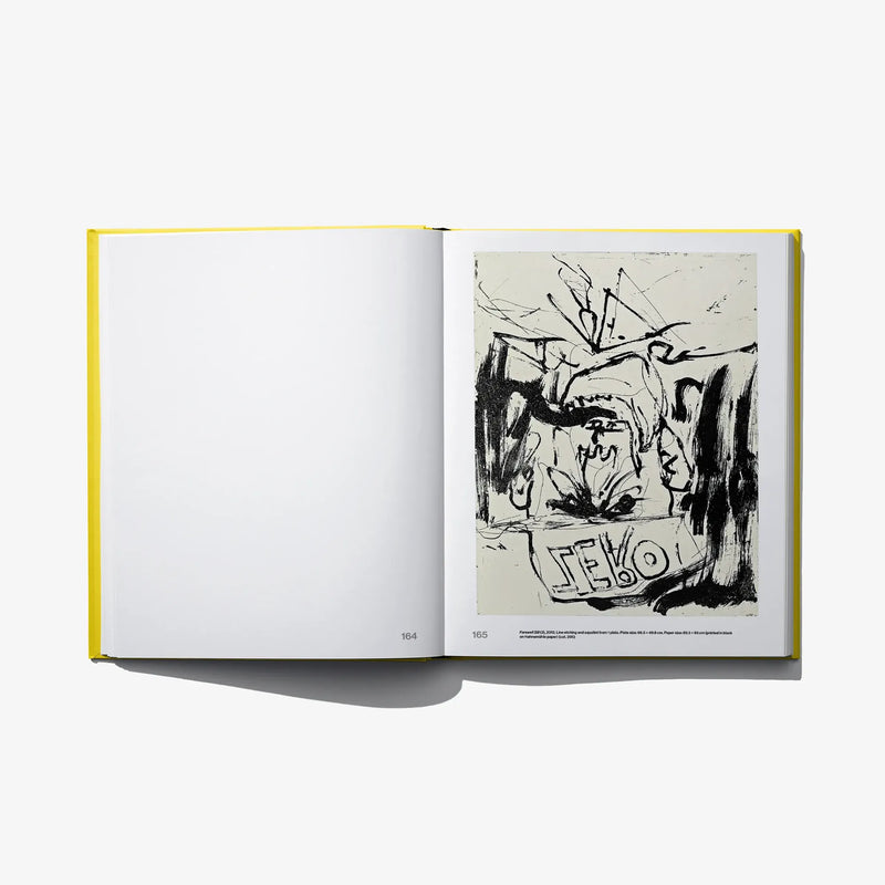 Opened art book with blank left page and black-and-white sketch print on right