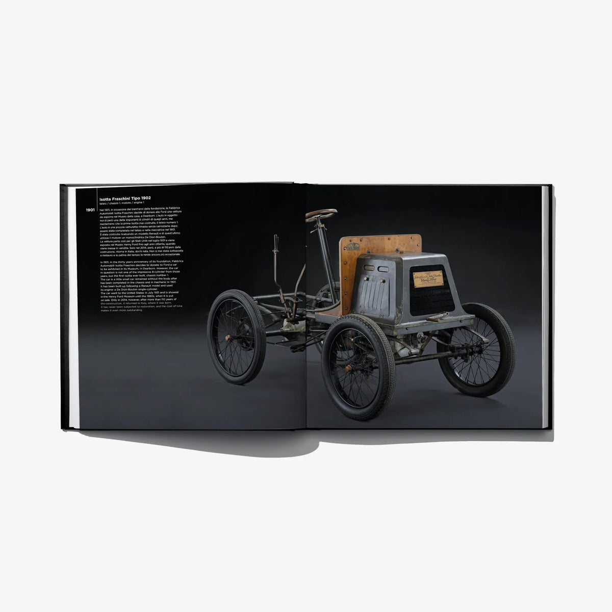 Open hardcover book spread showing a vintage car in profile