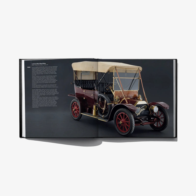 Open hardcover book spread featuring a maroon vintage car with tan top