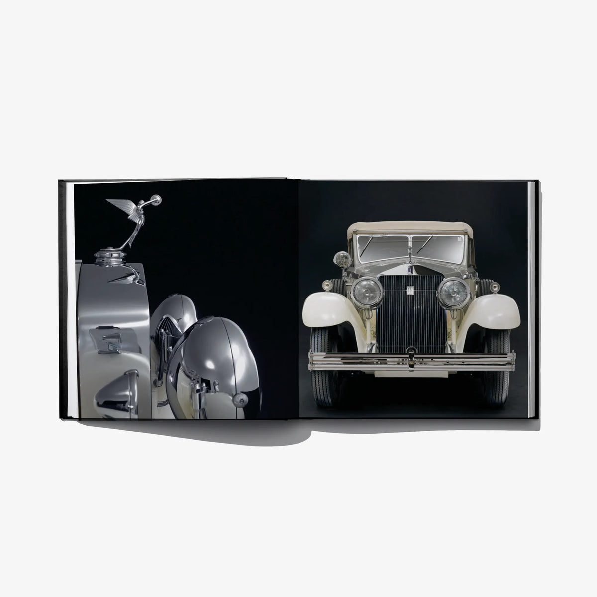 Open hardcover book spread with front view of a vintage silver car