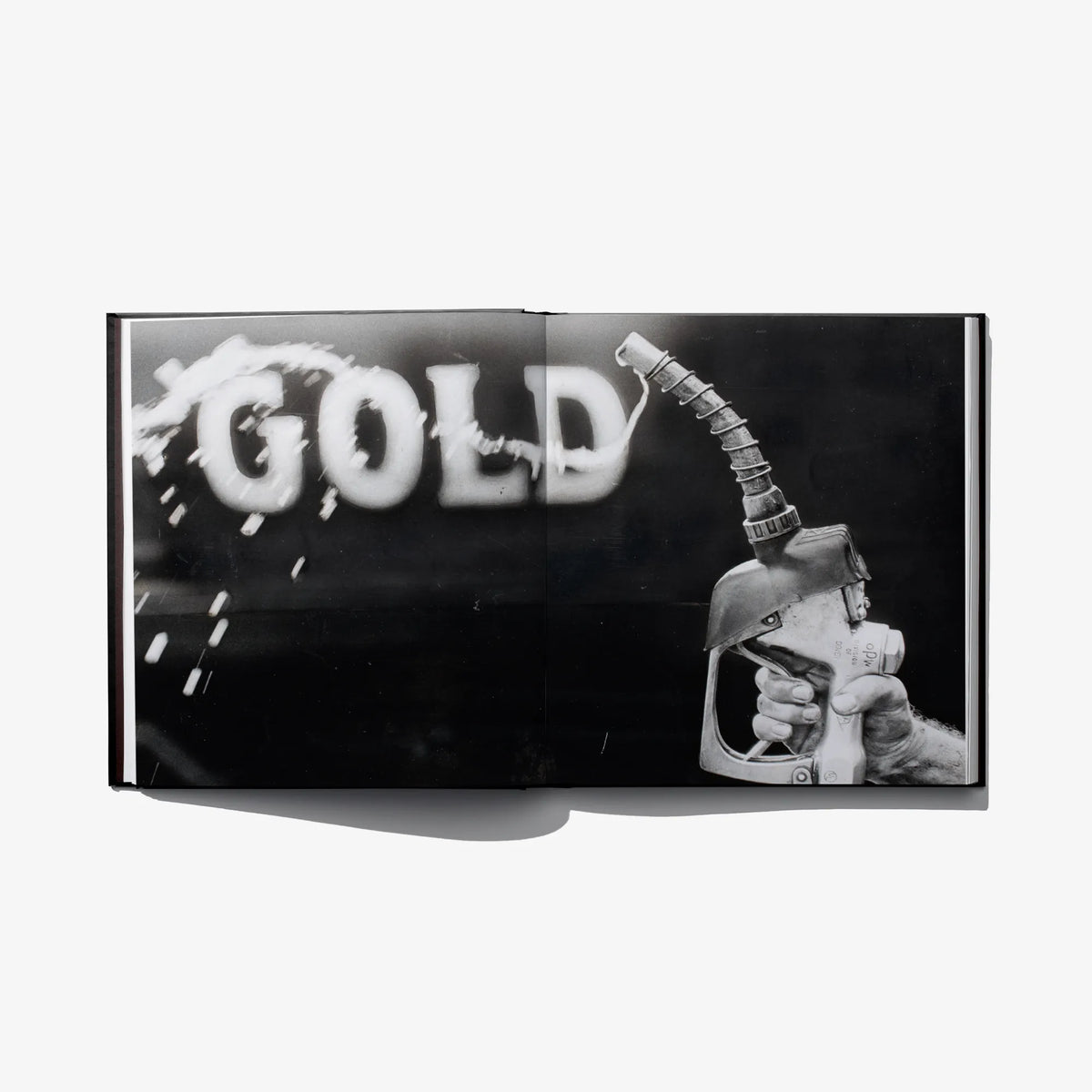 Open book cover panel with “GOLD” text and a hand holding a tool