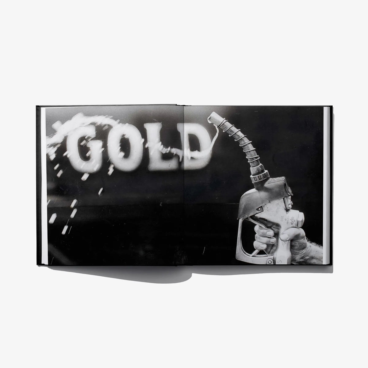 Hardcover art book with bold “GOLD” title and illustrated hand holding a pump