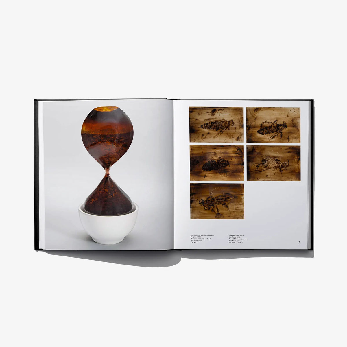 Open hardcover art book with orange hourglass image and a photo collage page