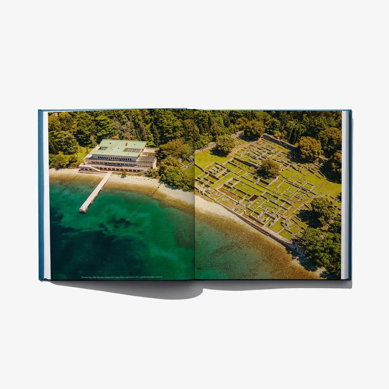 Open photo book spread with aerial marina, forest, and tiled garden layout.