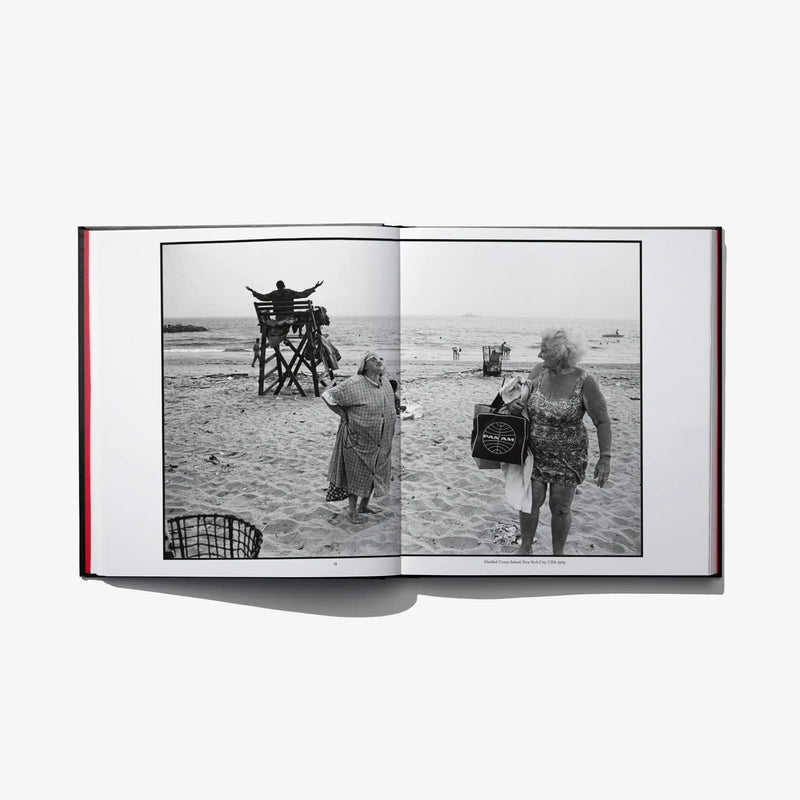 Open photo book spread with black-and-white beach snapshots