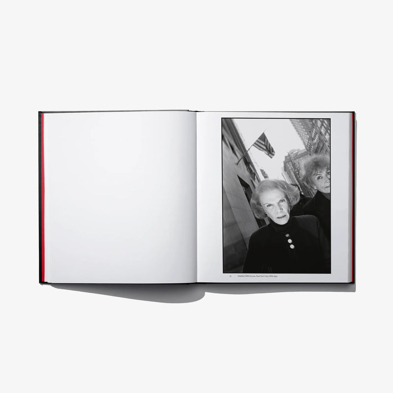 Open photo book spread with black-and-white portrait of an older woman