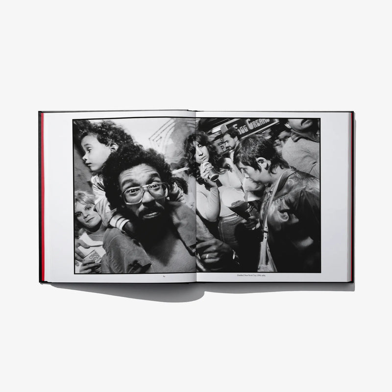 Open photo book spread with black-and-white crowd scene