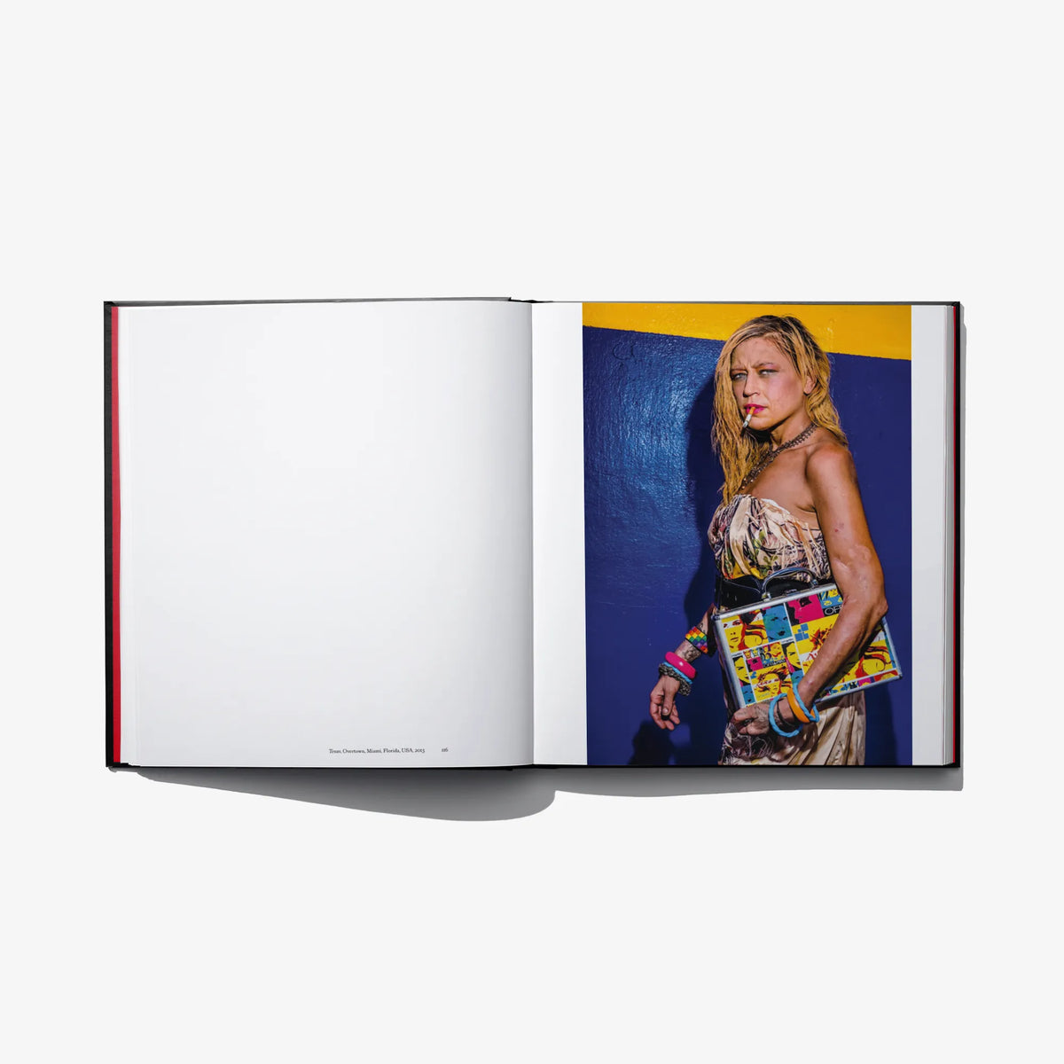 Open photo book spread with color portrait of a blonde woman holding toys
