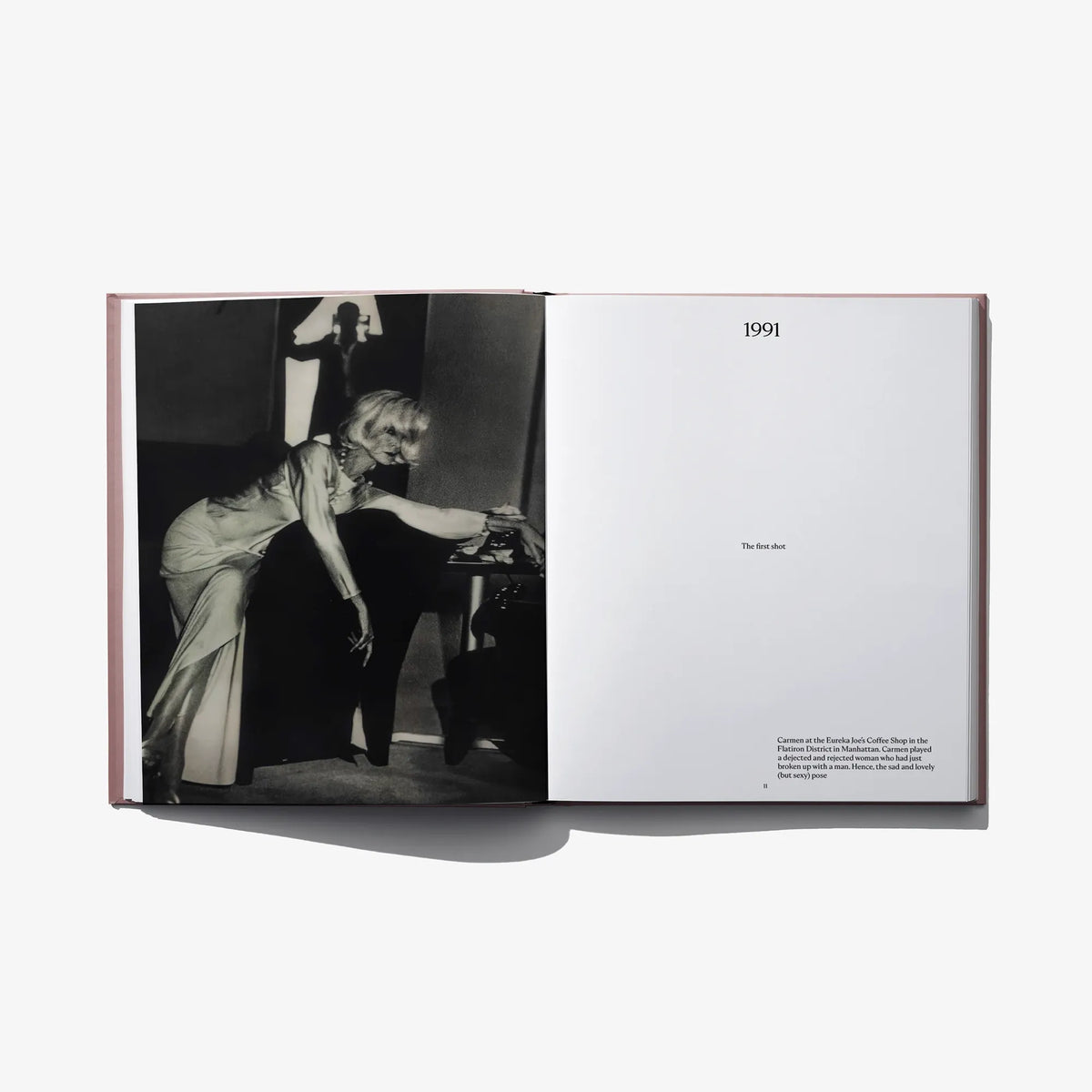 Open hardcover fashion book with black-and-white seated portrait photo