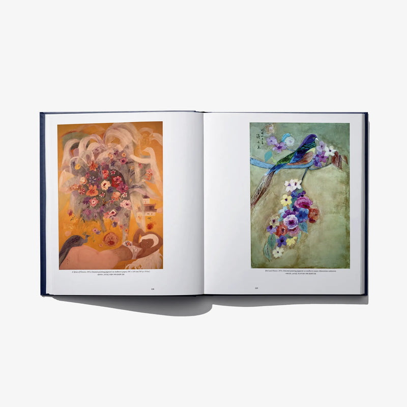 Open art book spread with two colorful framed artworks featuring flowers