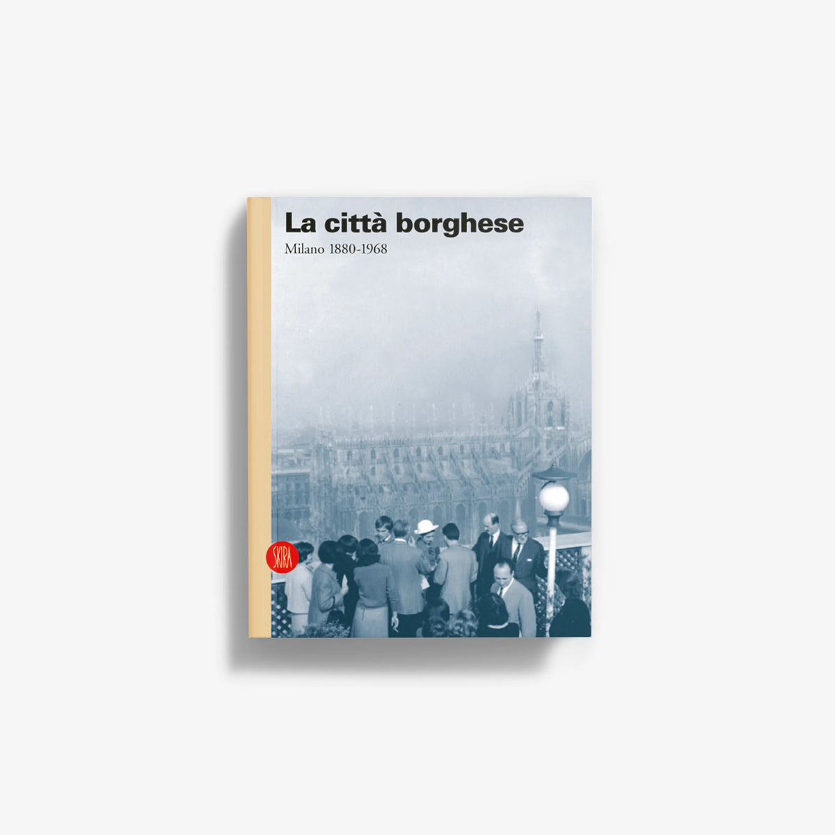 Paperback book with light blue cover, crowd photo, title text on top, red emblem