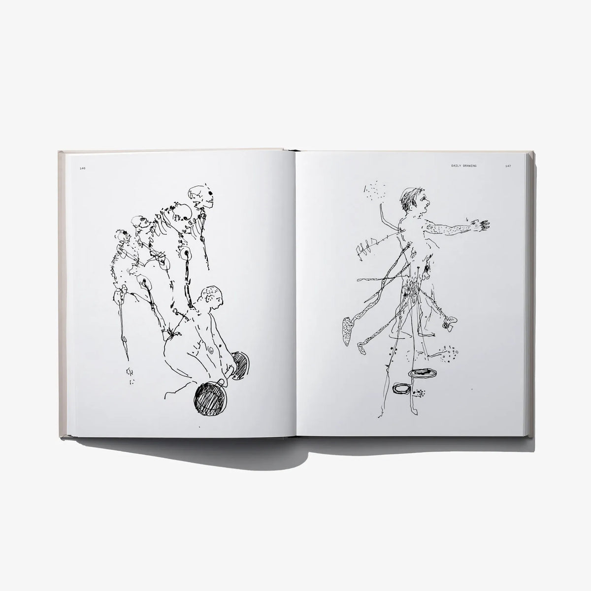 Open hardcover art book with two black-and-white line drawings of musicians