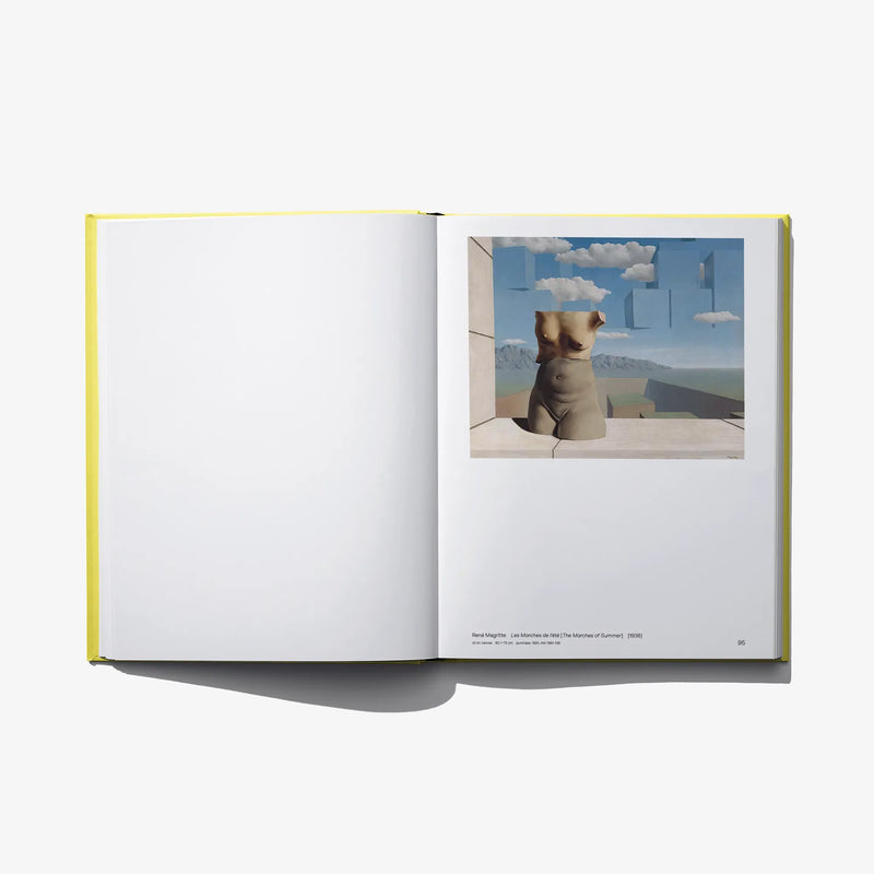 Open art book with blank left page and landscape photo panel on right