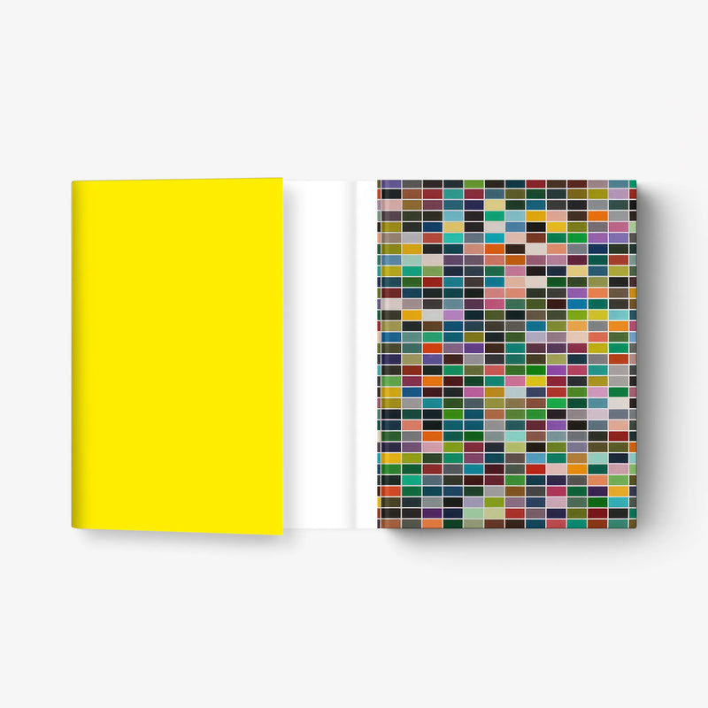 Book with bright yellow cover and open page with multicolor square mosaic print