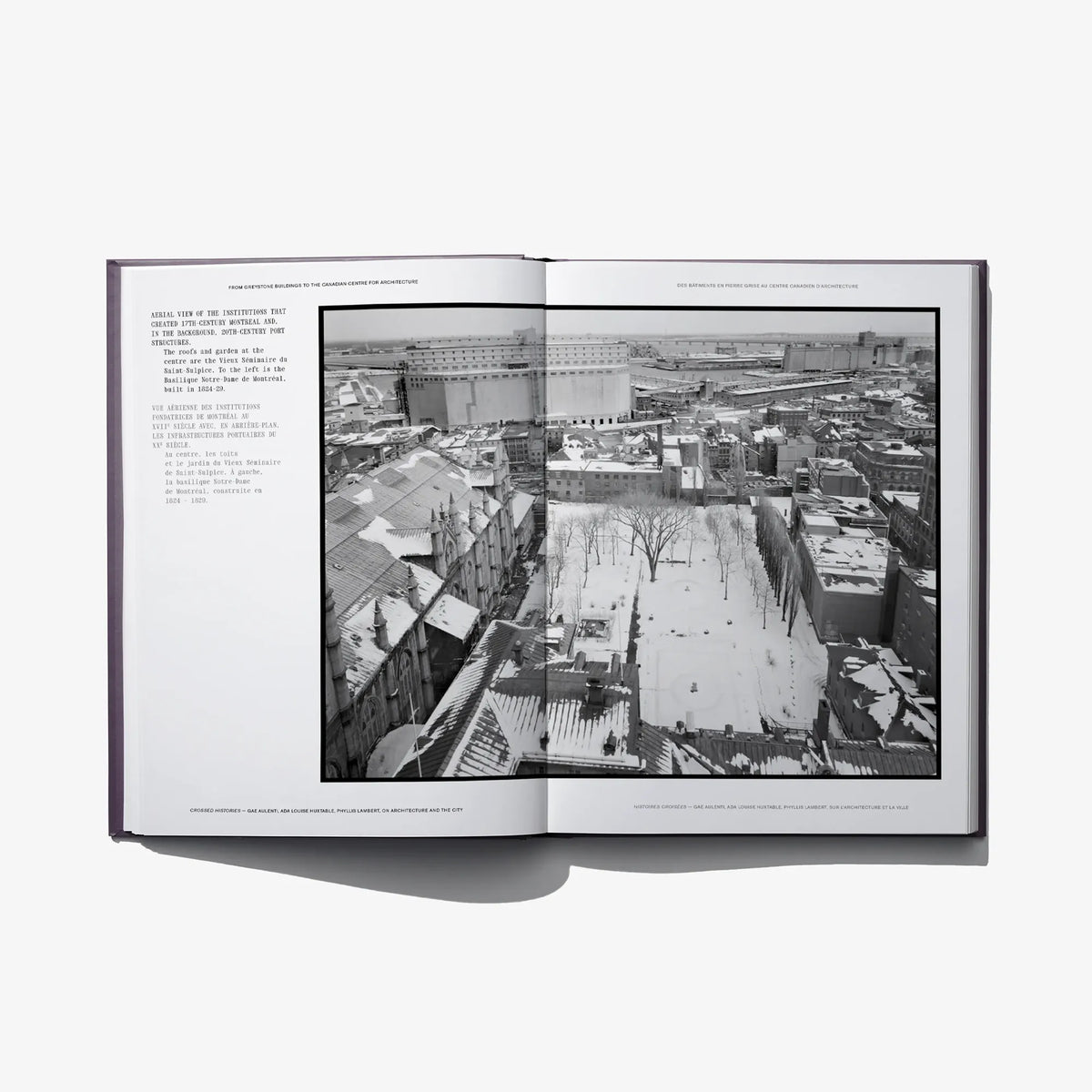 Open book with a black-and-white aerial facility photo and printed text