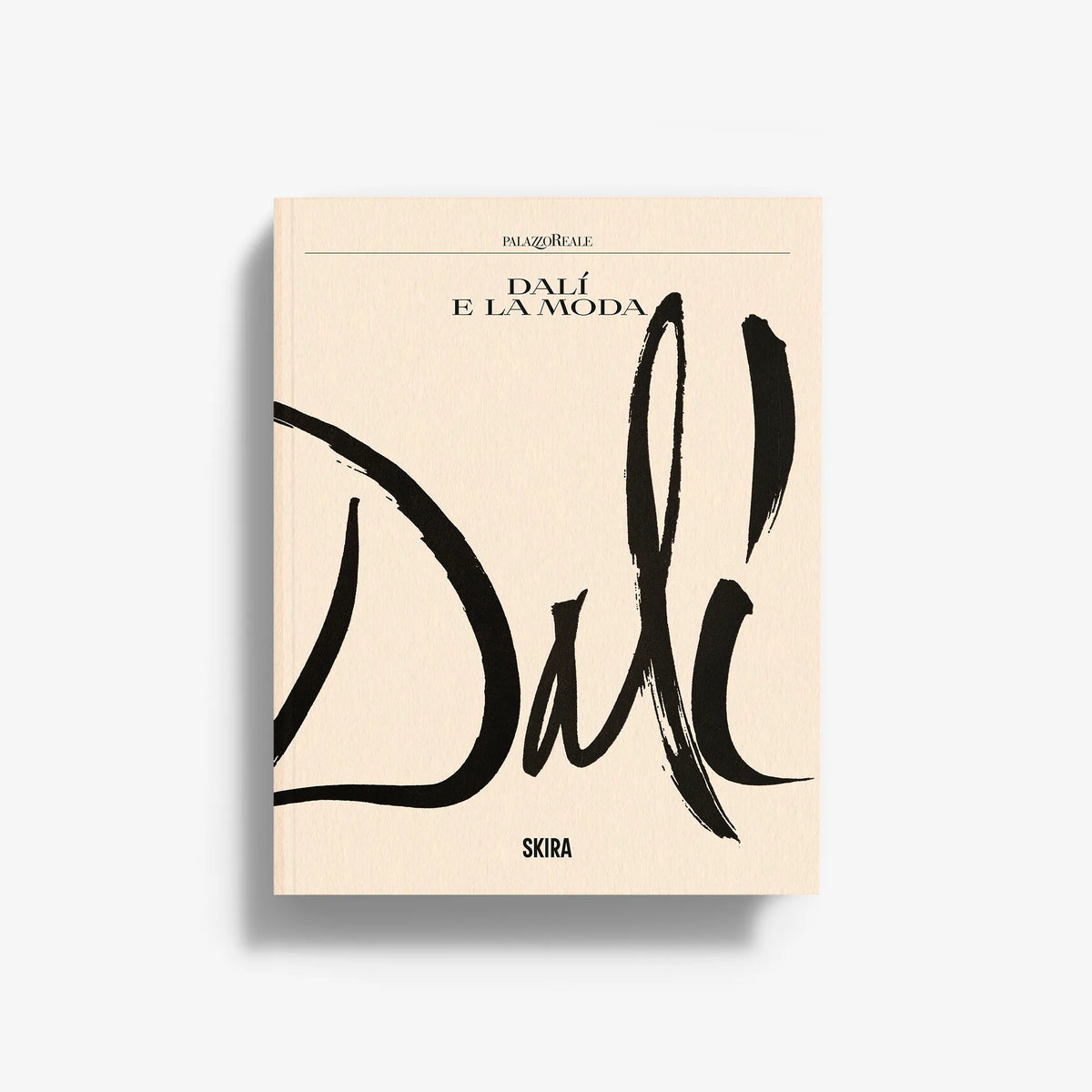 Dalí e la Moda hardcover book with cream cover and bold black brush lettering