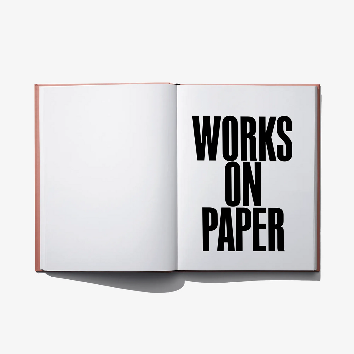 Open art book with bold black "WORKS ON PAPER" title text on right page