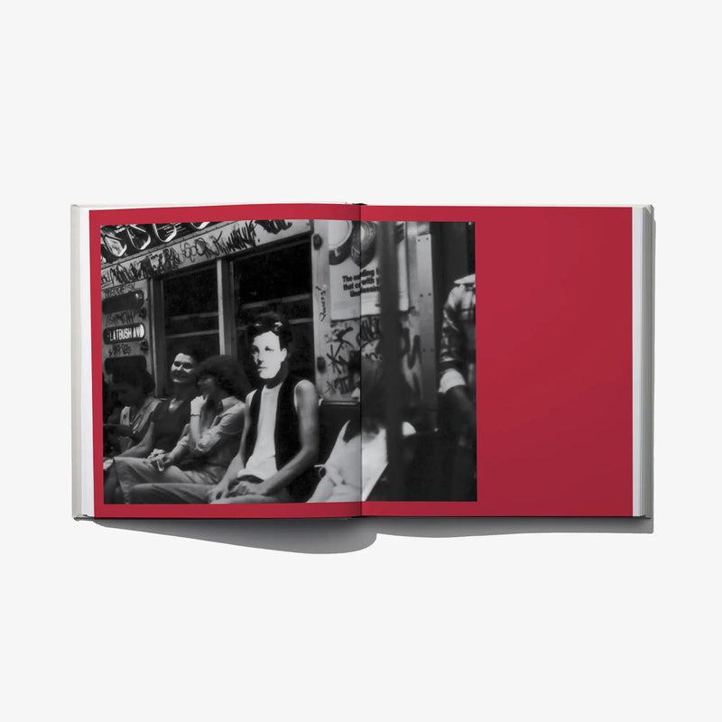 Open photo book spread with two black-and-white street photos on red page