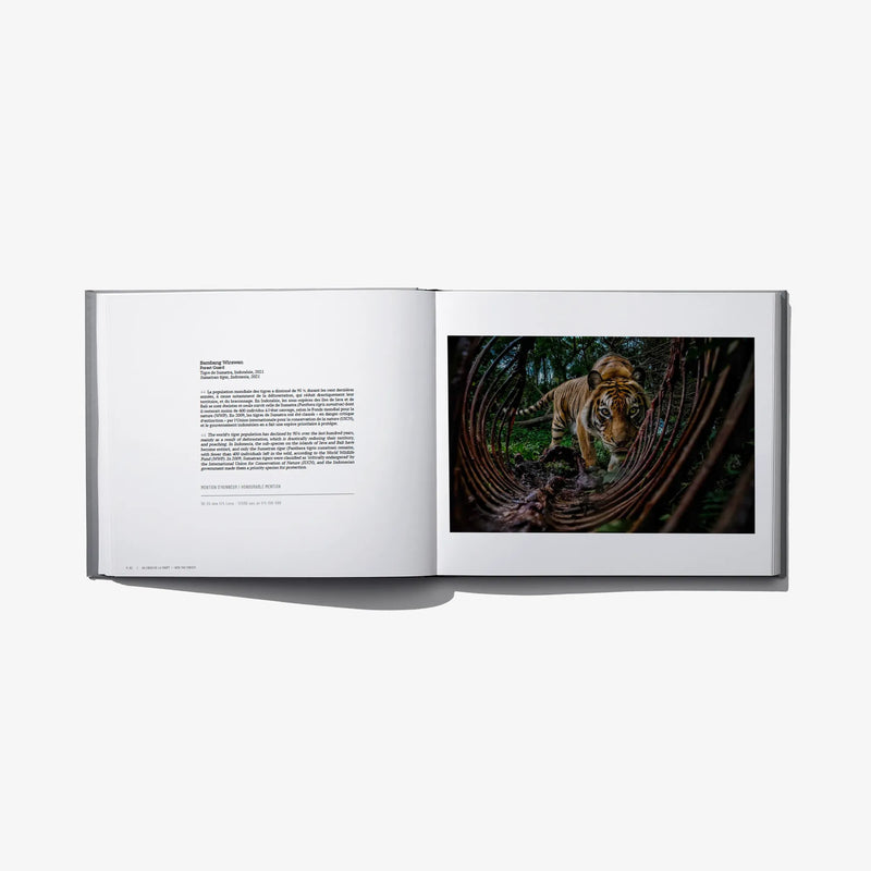 Hardcover photo award book open, white pages with dog in forest photo and printed text.