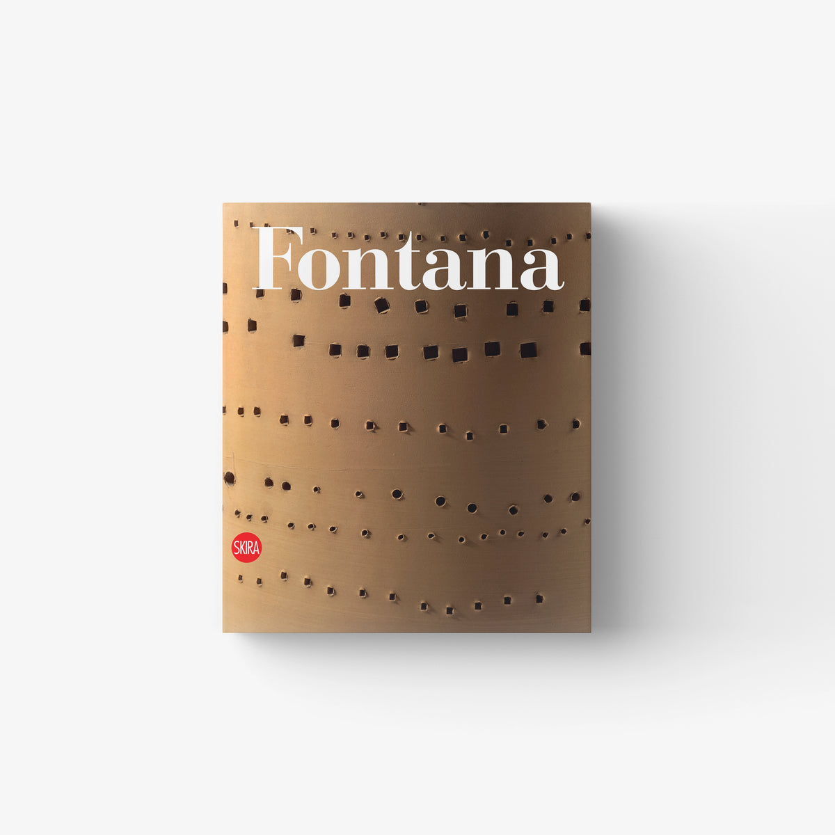 Art catalogue book in tan with cut-out pattern and Lucio Fontana title, published by Skira Arte, catalogo ragionato di sculture ceramiche