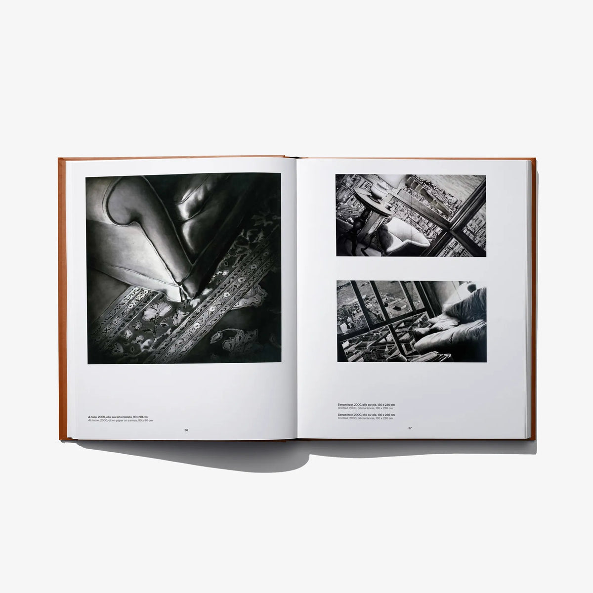 Open art book spread with close-up black-and-white photo collage panels