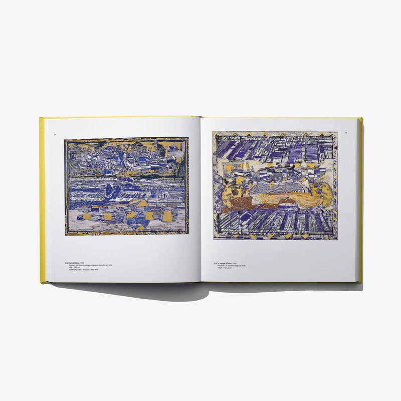 Open art book with blue and yellow abstract cityscape prints on two pages