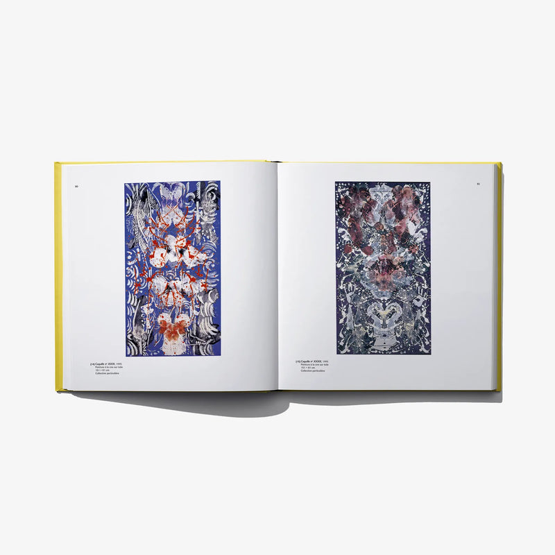 Open art book with blue and brown abstract pattern prints on two pages