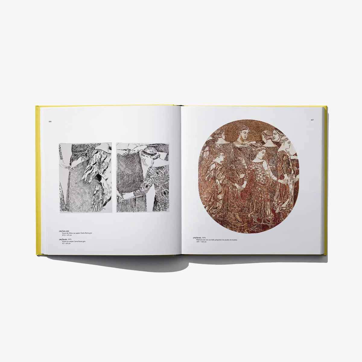 Open art book with black-and-white figures and a brown circular artwork