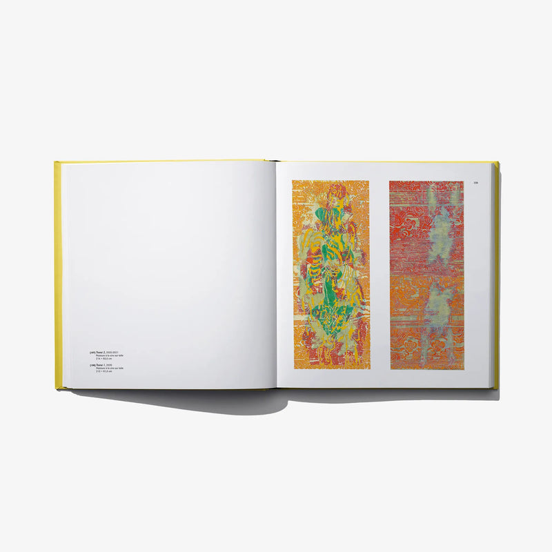 Open art book with orange and red abstract prints on two pages