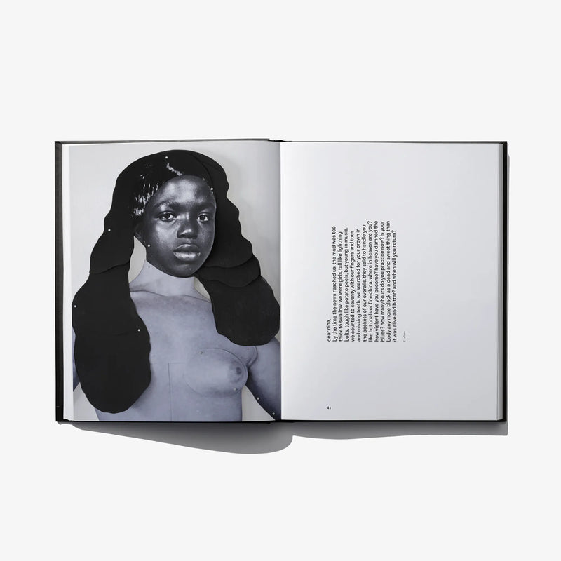 Open photo book spread with woman portrait wearing a black headwrap