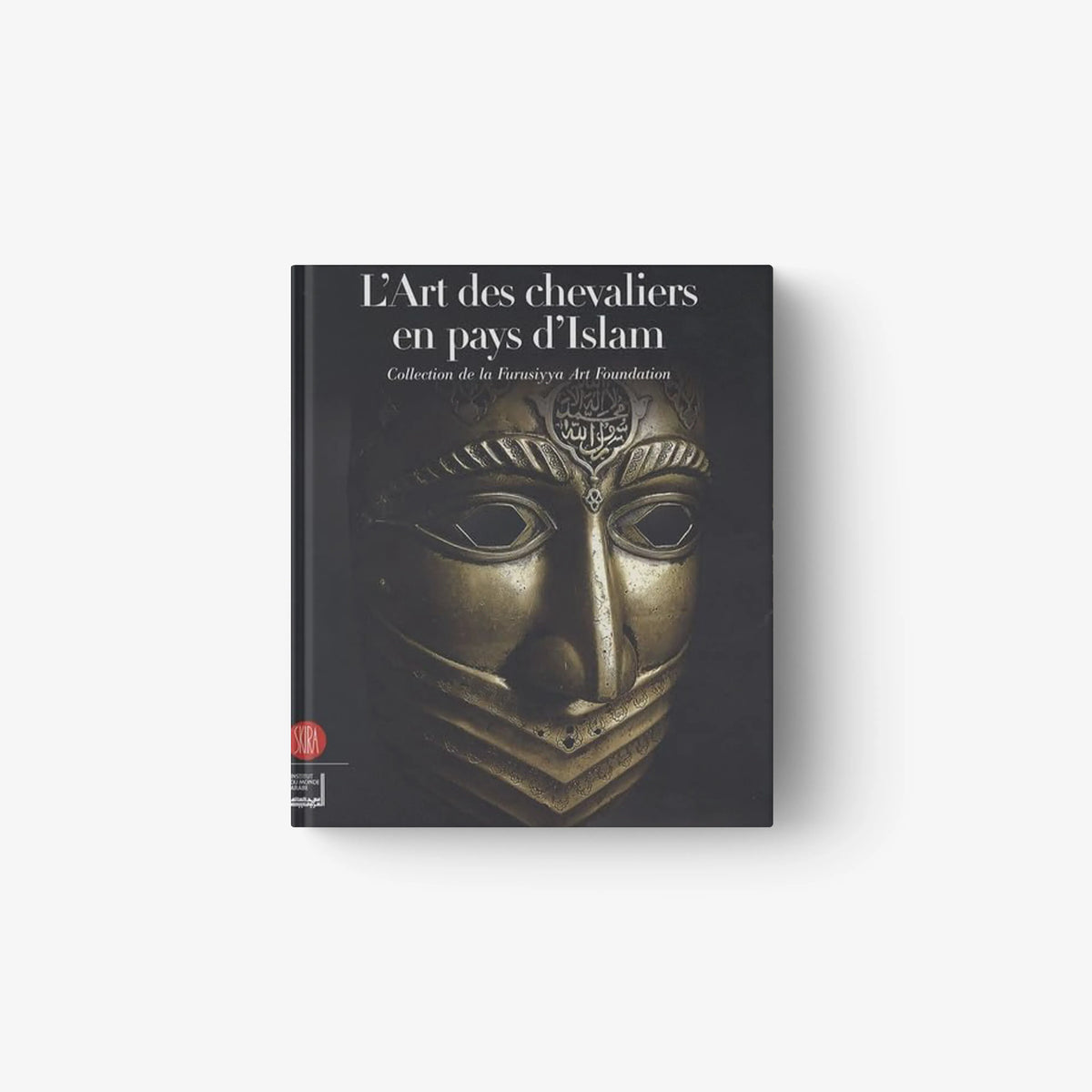 Hardcover book with dark cover and gold decorative face mask