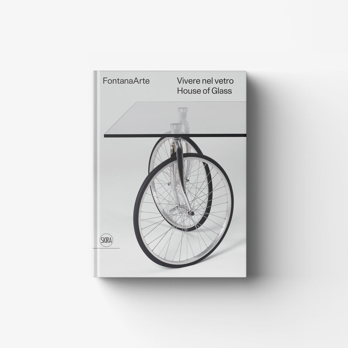 Glass book cover by Skira Arte for FontanaArte Vivere nel vetro, with bicycle wheel and House of Glass text
